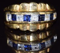 An 18ct gold ring set with synthetic sapphires and paste, 6.3g, size T