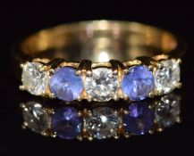 An 18ct gold ring set with two tanzanites and three diamonds, each diamond approximately 0.2ct, 3.