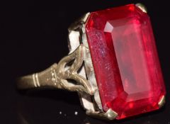 A 9ct gold ring set with an emerald cut synthetic ruby, 7.5g, size O