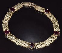 A 9ct gold bracelet set with heart cut garnets, 7.5g, 20cm long