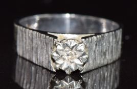 A 9ct white gold ring set with a diamond in an illusion setting, 3.2g, size J