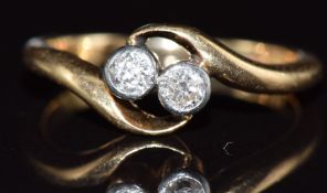 An 18ct gold ring set with two diamonds in a twist setting, 2.2g, size G/H