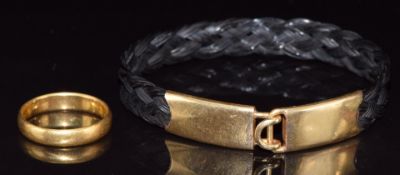 A 22ct gold wedding band Birmingham 1911, 4.2g and a plaited elephant hair bracelet with yellow