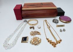 A collection of costume jewellery including rolled gold bangle, brooches, necklace, Stratton