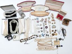 A collection of costume jewellery including rings, vintage brooches, faux pearls, fresh water
