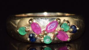 A 9ct gold ring set with rubies, sapphires and emeralds, 3.1g, size J
