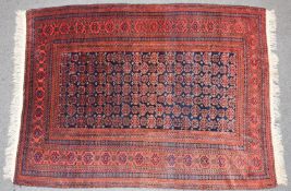 Afghan eko Belouch / Baluch wool rug with multiple guls and borders on a wine ground, 229 x 168cm