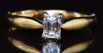 An 18ct gold ring set with an emerald cut diamond of 0.36ct, with original insurance valuation,