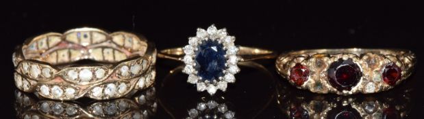 Three 9ct gold rings, one set with a sapphire and diamonds, one spinel and the other garnets, 8g