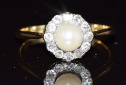 A c1920 18ct gold ring set with a pearl surrounded by diamonds, 2.8g, size O