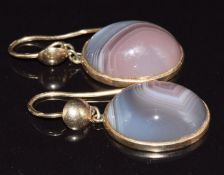 A pair of c1900 9ct gold earrings set with a lace agate cabochon to each, 9g