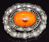 Georg Jensen silver brooch set with a pressed amber cabochon, stamped Georg Jensen and 109