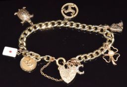 A 9ct gold charm bracelet with seven 9ct gold charms including enamel card, turtle, four leaf