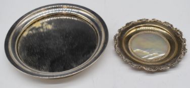 Two hallmarked silver mounted coasters or pin trays, the larger having a mirror base, the smaller