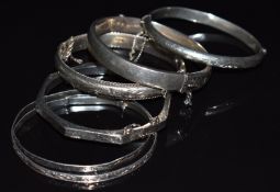 Six silver bangles with engraved foliate decoration, one an octagonal example