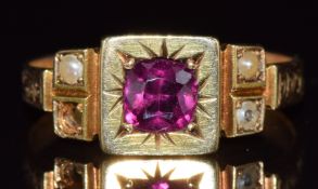 A 15ct gold ring set with a cushion cut garnet and seed pearls, Birmingham 1901, 2.8g, size K
