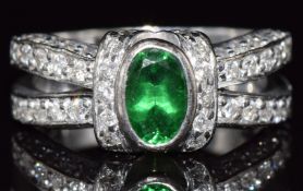 An 18ct white gold ring set with an oval cut tourmaline and diamonds, 8g, size L