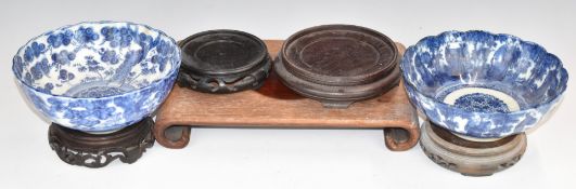 Five Chinese hardwood stands and two Japanese pedestal bowls, largest stand 31 x 20cm, bowls H7 x