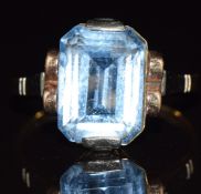 An 18ct gold ring set with an emerald cut blue topaz, 3.4g, size O