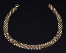 A 9ct gold necklace made up of domed rectangular links, 25.6g, 47cm long