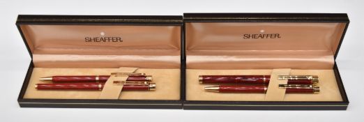 Two boxed Sheaffer White Dot fountain pen and ballpoint pen sets, both with red marbled bodies and
