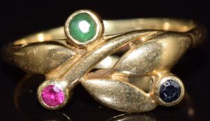 An 18ct gold ring set with an emerald, ruby and sapphire, 3.2g, size K