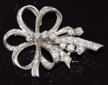 An 18ct white gold brooch set with diamonds in a stylised bow design, 6.4g, size 3.5cm