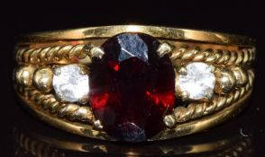 A 14k gold ring set with with a garnet and topaz, 5.6g, size N