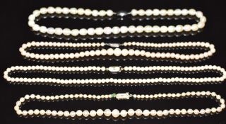 Two single strands of cultured pearls with 9ct gold clasps and two pearl necklaces with silver