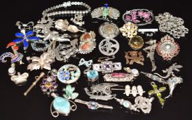 A collection of silver brooches/ pendants including amethyst thistle, turquoise, garnet, pearl,