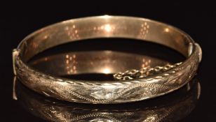 A 9ct gold bangle with engraved decoration, 10.4g, 6 x 5.4cm