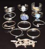 Eleven silver bangles including serpent, labradorite, etc and a silver charm bracelet