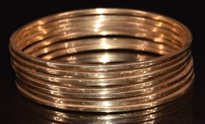 Seven 18ct gold bangles, 30.9g.