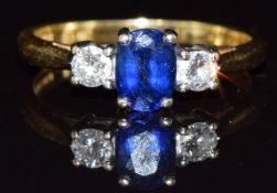 An 18ct gold ring set with an oval cut sapphire of approximately 0.5ct and diamonds, 2.8g, size K