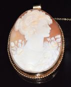 A 9ct gold pendant/brooch set with a large cameo depicting a young woman, 24.4g, 6 x 4.8cm