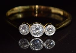 An 18ct gold ring set with three diamonds, the centre stone approximately 0.22ct, in antique box,