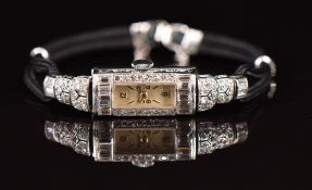 Garrard retailed Art Deco platinum ladies wristwatch with diamond set engraved case, gold hands,