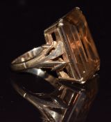 A 9ct gold ring set with an emerald cut smoky quartz, 9g, size K