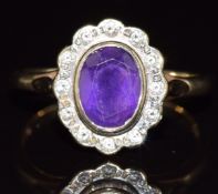 A 9ct gold ring set with an oval cut amethyst surrounded by diamonds, 3.6g, size P