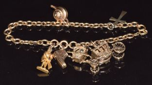 A 9ct gold bracelet made up of circular links with five 9ct gold charms including boot, teapot,
