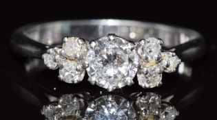 A platinum ring set with a diamond of approximately 0.57ct and further diamonds to shoulders,