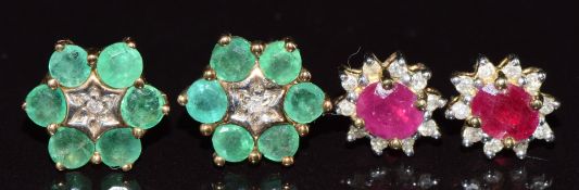 Two pairs of 9ct gold earrings, one set with a diamond and emeralds and the other pair a ruby and