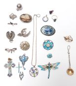 A collection of jewellery including enamel pendant set with a pearl, silver brooches, enamel