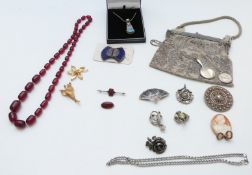 A collection of jewellery including miniature silver hand mirror, Miracle pendant, filigree