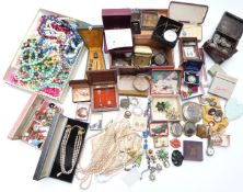A collection of costume jewellery including silver bangle, vintage brooches, beads, jet brooch,