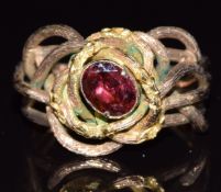 A 9ct gold ring set with a foiled garnet in a knotted textured setting, 5.5g, size N