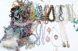 A collection of beaded necklaces including tiger's eye, garnet, agate, glass, opalized beads, silver