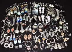 Sixty pairs of silver earrings including coral, mother of pearl, amethyst, marcasite, pearls, etc