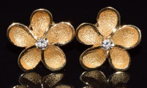 A pair of French 18ct gold earrings in the form of a flower set with a diamond to each, 3.3g