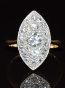 An 18ct gold ring set with diamonds in a platinum navette shaped setting, the largest diamond